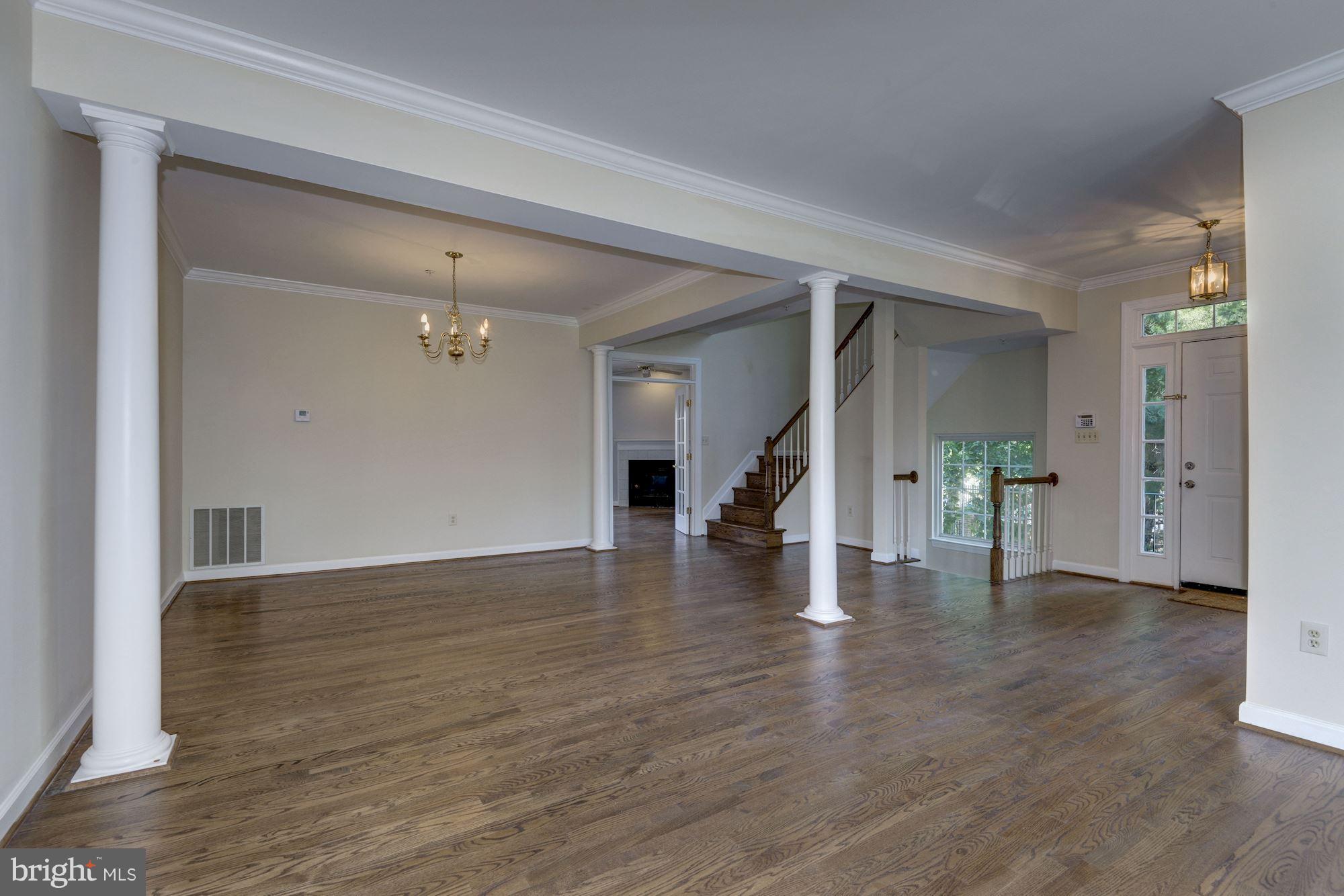 2101 Hounds Run Place Silver Spring, MD 20906 - Photo 5 of 30 an empty room with wooden floor and a ceiling fan