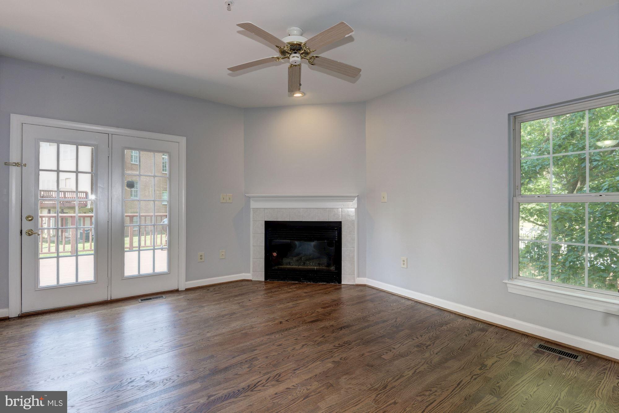 2101 Hounds Run Place Silver Spring, MD 20906 - Photo 9 of 30 an empty room with windows and a fireplace