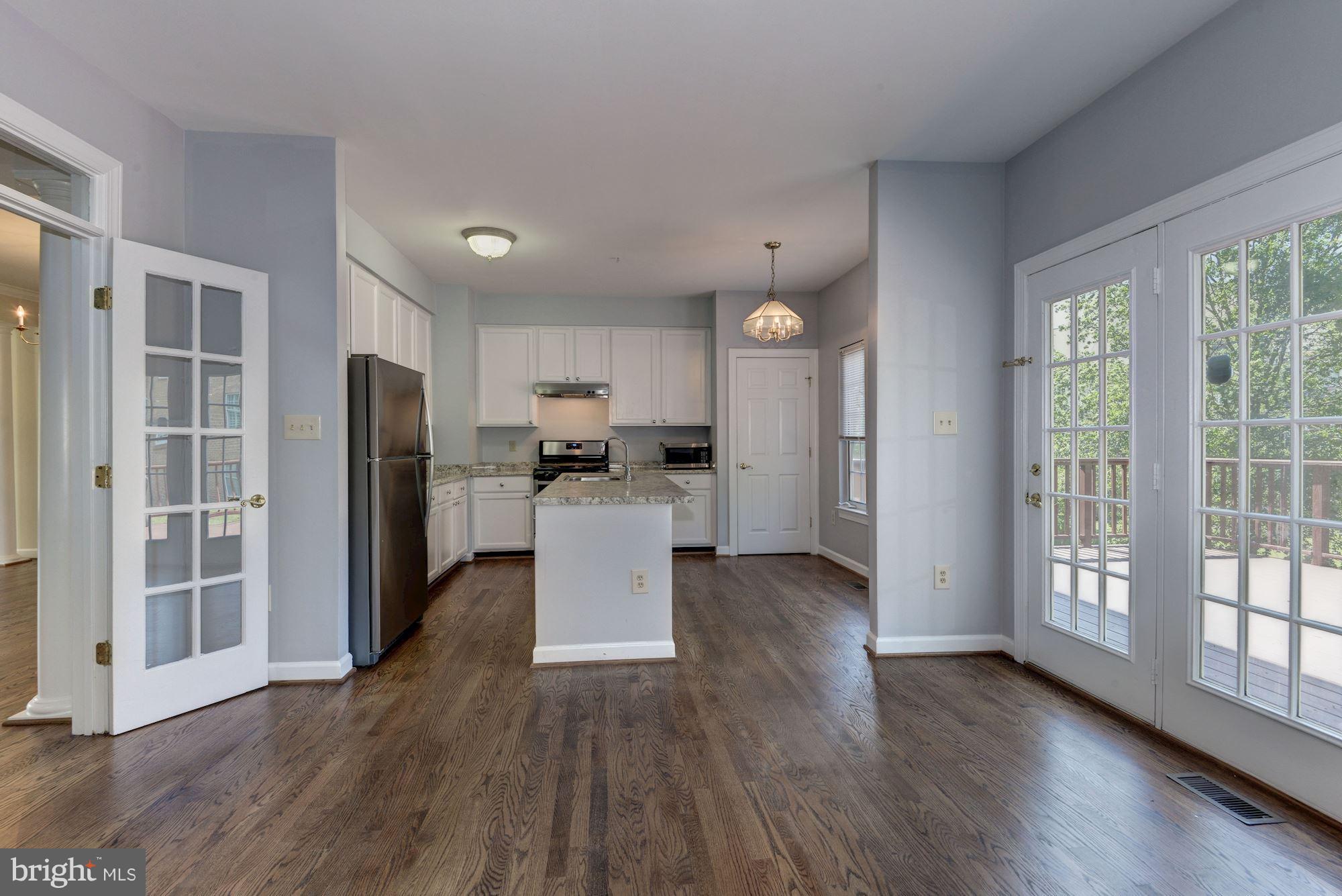 2101 Hounds Run Place Silver Spring, MD 20906 - Photo 10 of 30 a view of kitchen with refrigerator and wooden floor