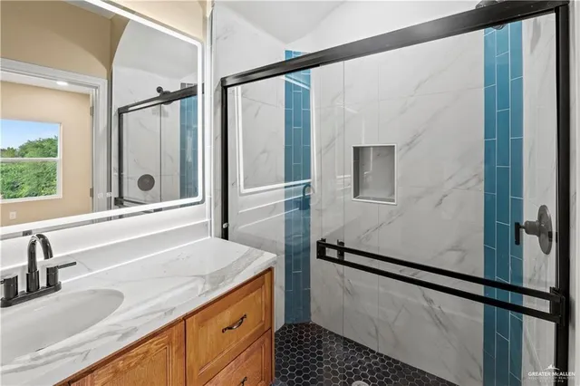 a bathroom with a sink and a large mirror