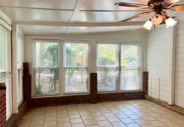 a front view of a house with a garden and trees