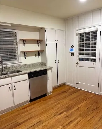 a view of kitchen with cabinets and wooden floor