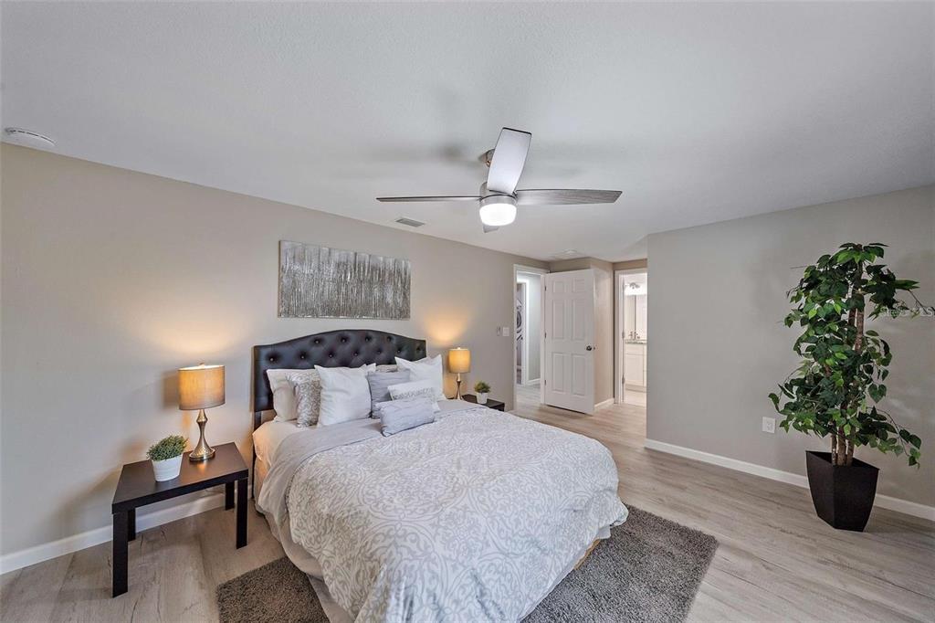 105 Clemson Road Venice, FL 34293 - Photo 12 of 15 a bedroom with a bed and a potted plant