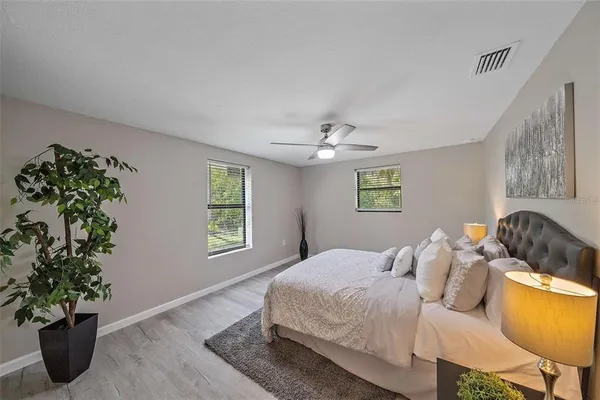 a bedroom with a bed and a potted plant
