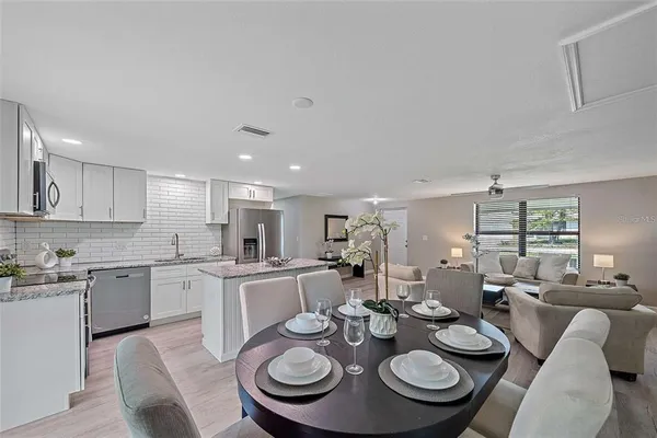 a kitchen with a dining table and chairs