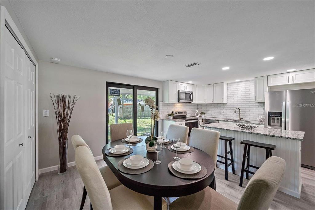 105 Clemson Road Venice, FL 34293 - Photo 8 of 15 a view of a dining room with furniture and a kitchen