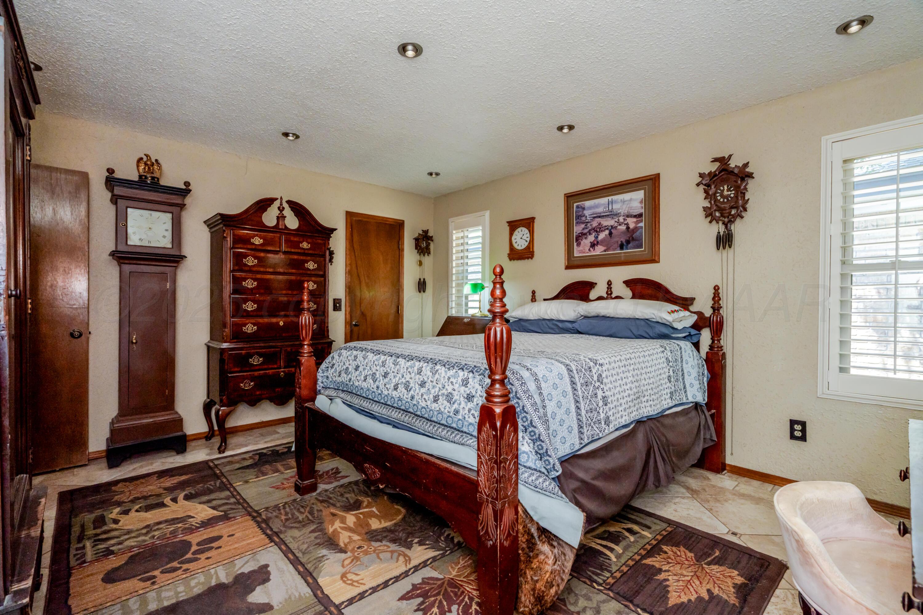 3908 Lewis Drive Amarillo, TX 79109 - Photo 17 of 36 a bedroom with a bed and a dresser in it
