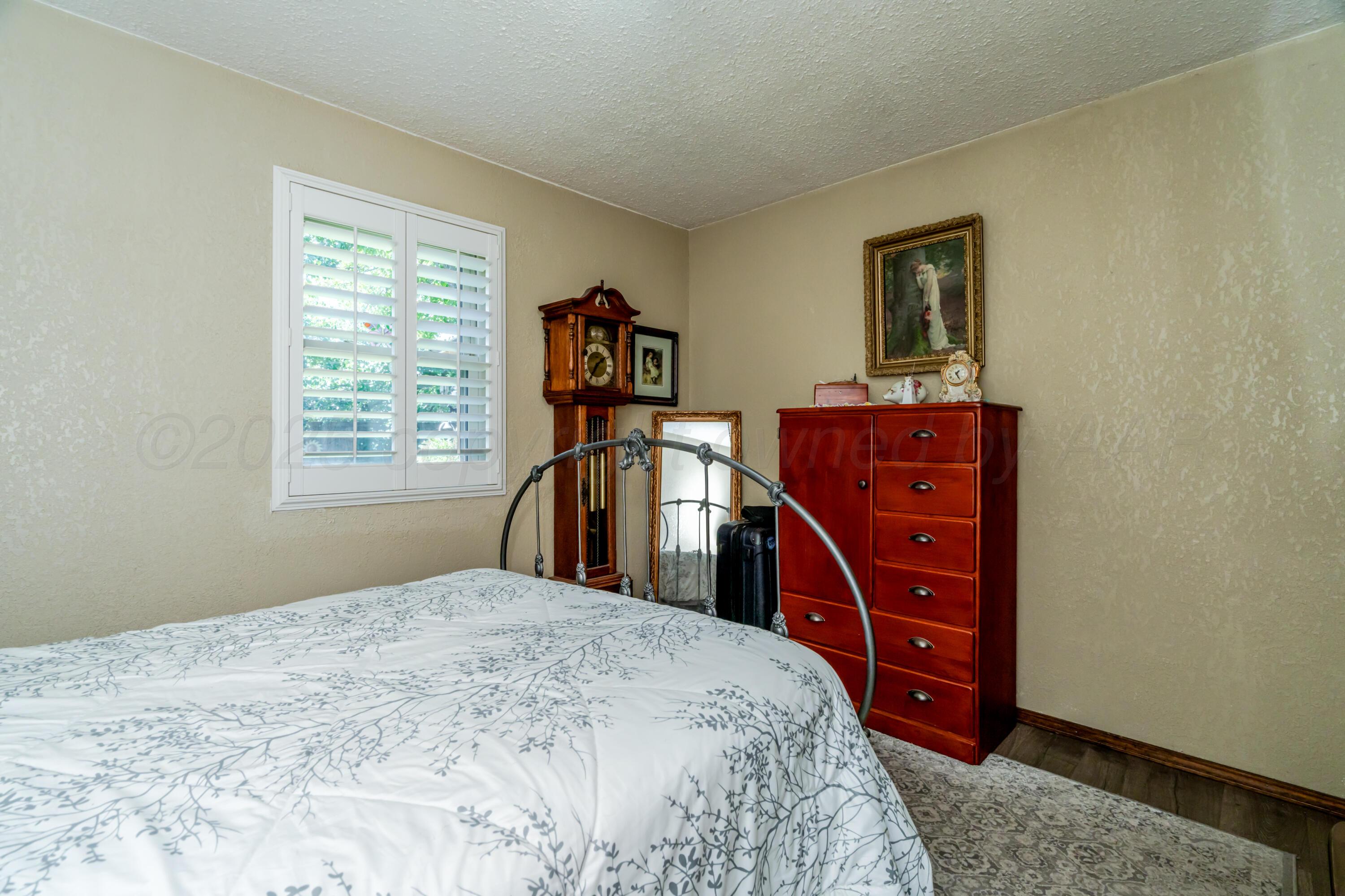 3908 Lewis Drive Amarillo, TX 79109 - Photo 26 of 36 a bedroom with a bed and a dresser