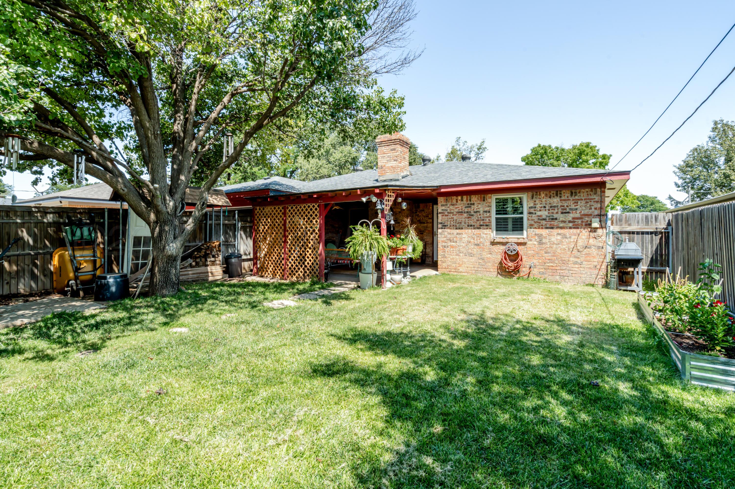3908 Lewis Drive Amarillo, TX 79109 - Photo 34 of 36 a view of a backyard with table and chairs and potted plants