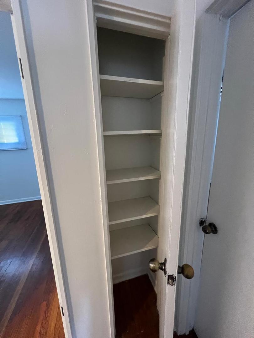 16442 Honore Avenue Markham, IL 60428 - Photo 7 of 16 a view of walk in closet with empty racks