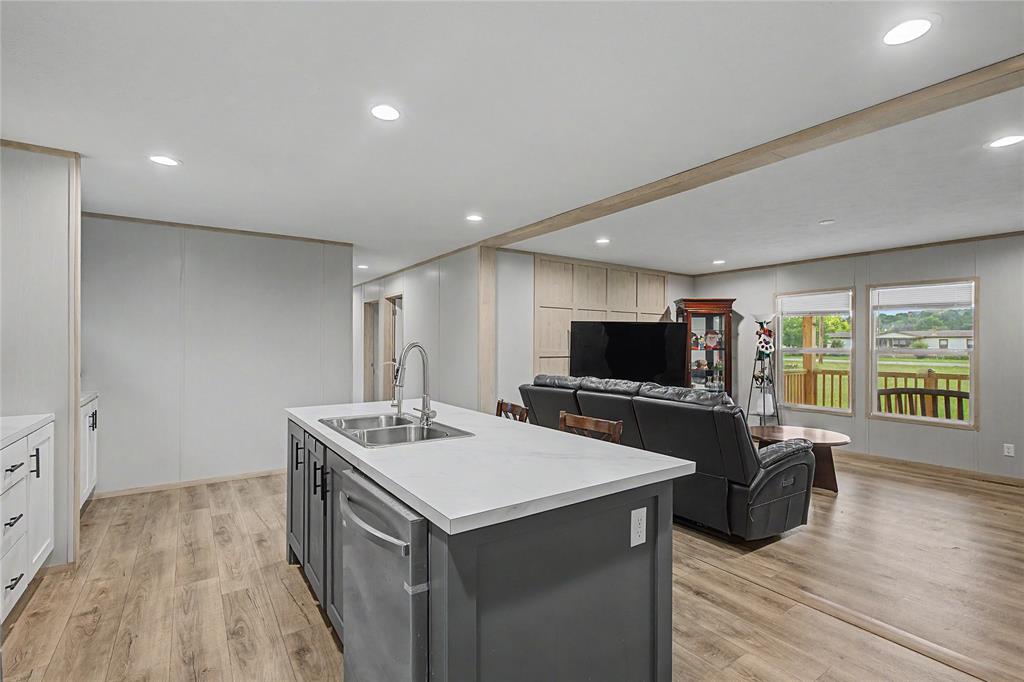 6065 Timber Trail Azle, TX 76020 - Photo 10 of 33 a kitchen with a sink and a stove top oven