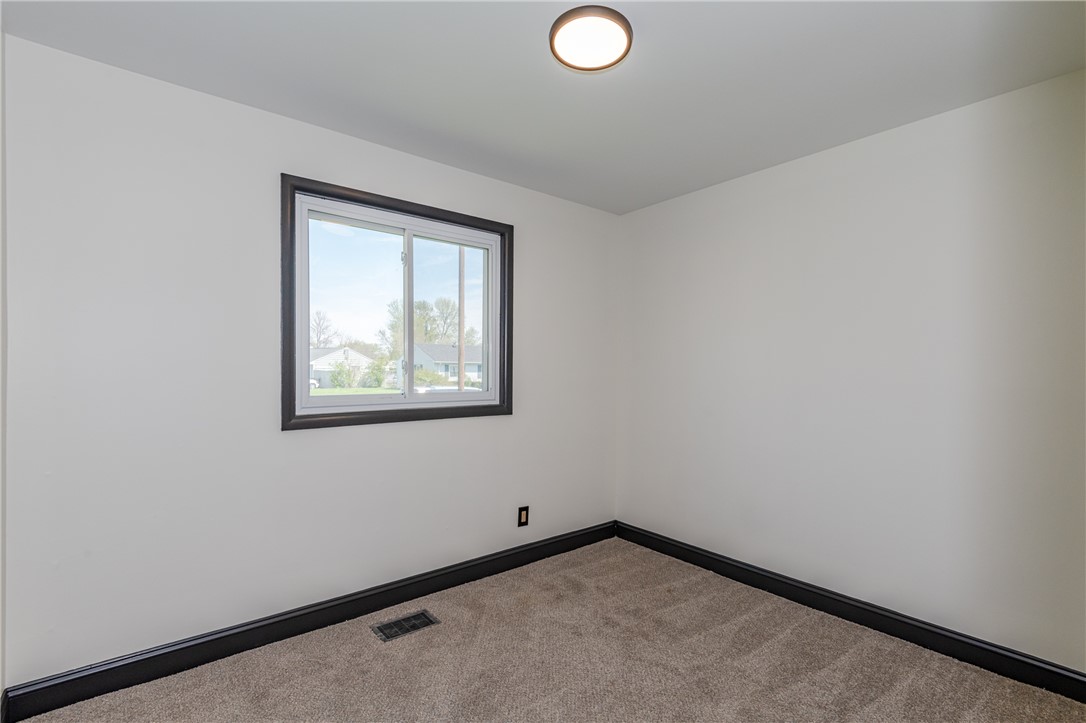 5240 Haverfield Road Dayton, OH 45432 - Photo 42 of 58 Bright and airy room with plush carpet, offering a versatile living space.