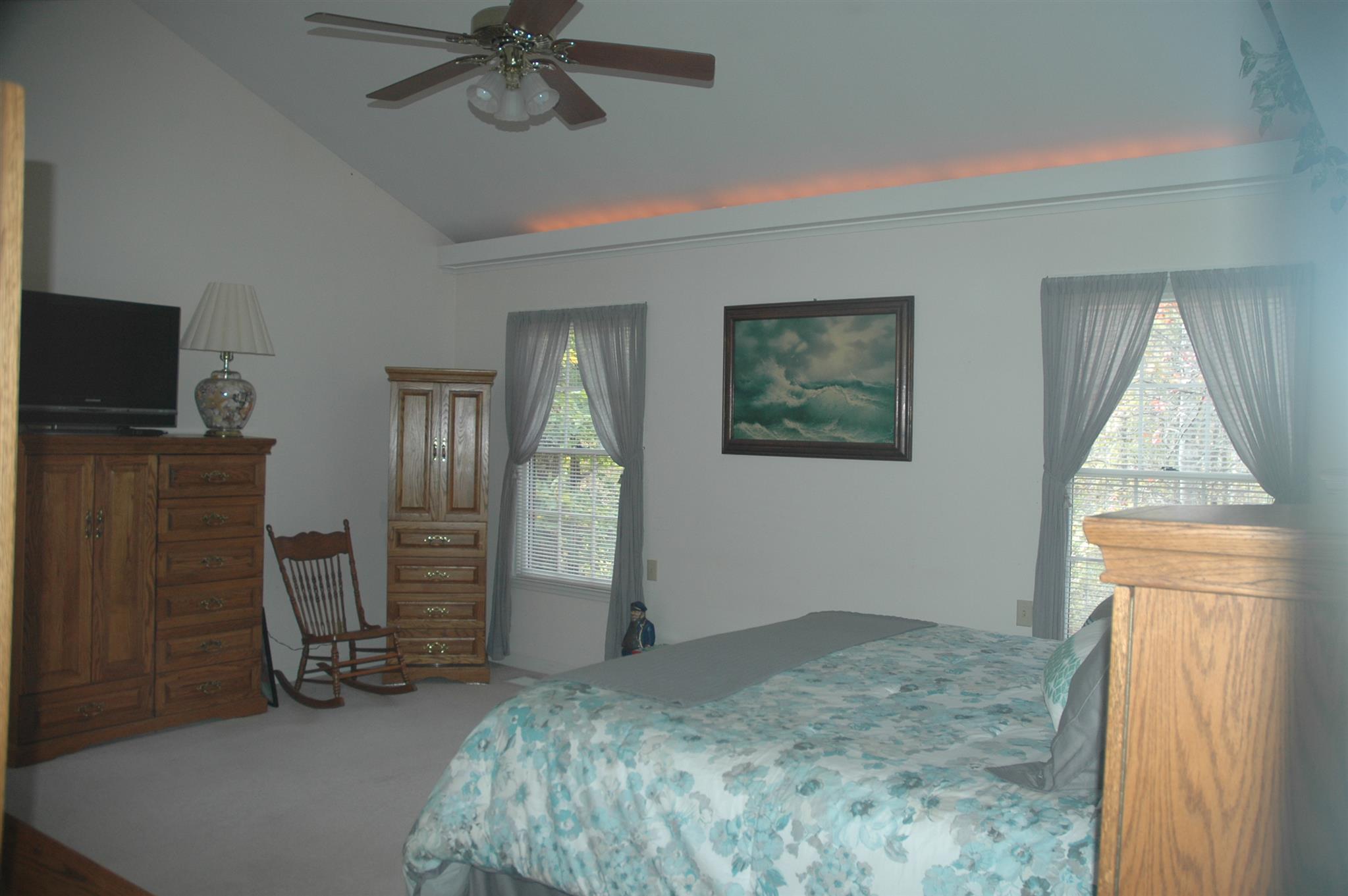 8765 Griffith Road Nashville, TN 37221 - Photo 7 of 27 Master bedroom with ceiling fan and lighting above the moulding