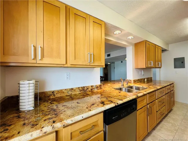 a kitchen with stainless steel appliances granite countertop a sink and a stove top oven