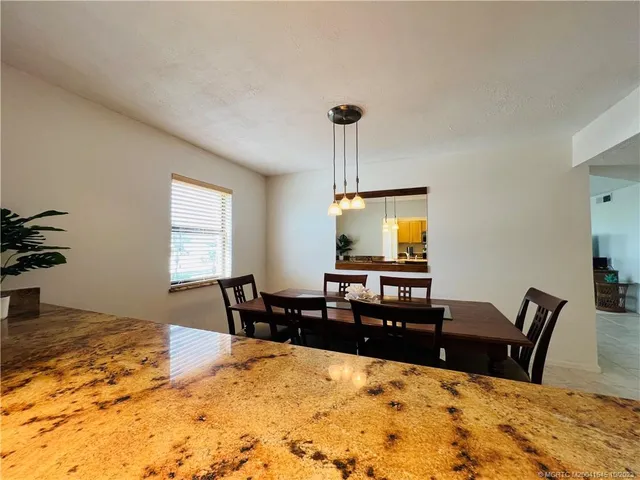 a view of a dining room and a table and chairs