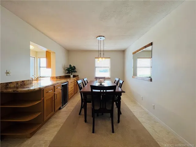 a living room with furniture and a potted plant on table