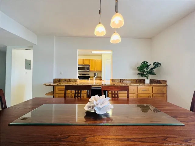 a dining room with furniture and a floor to ceiling window