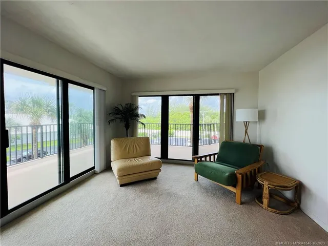 a bedroom with a large bed and a dresser next to a window