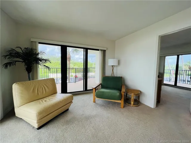 a bedroom with a bed and a view of kitchen