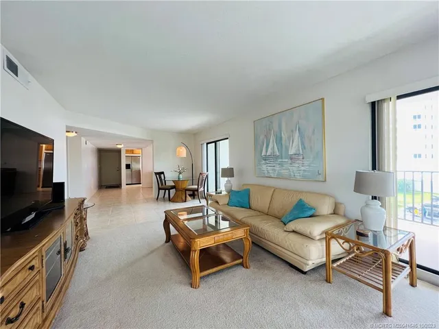 a bedroom with a bed and a large mirror on dresser