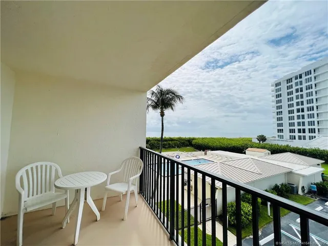 a kitchen with a granite countertop sink stove and cabinets