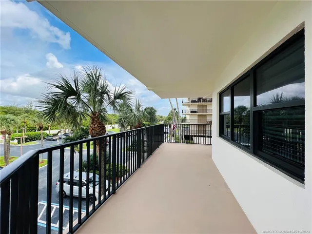 a bedroom with a bed and a flat tv screen on dresser