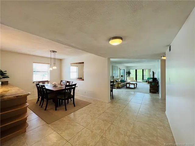 a kitchen with stainless steel appliances granite countertop a refrigerator a stove and a sink with wooden floor