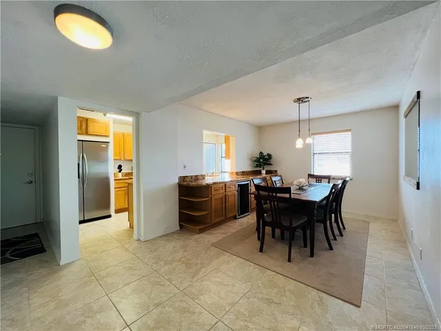 a kitchen with stainless steel appliances granite countertop a refrigerator a stove a sink and a microwave