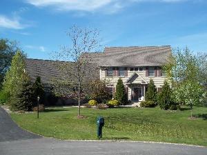 a front view of a house with a garden