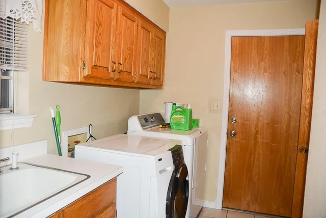 a utility room with a sink washer and dryer