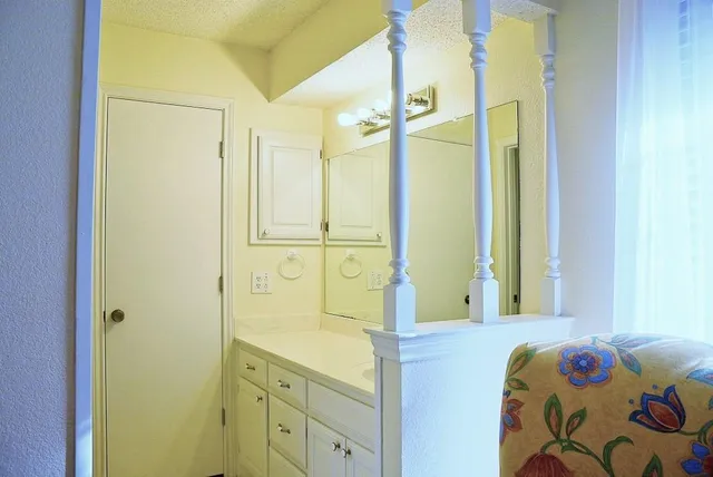 a bathroom with a tub a sink and a window