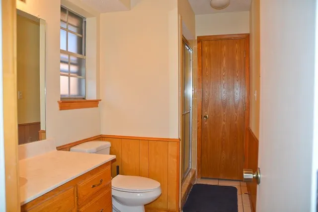 a bathroom with a toilet a sink and a window