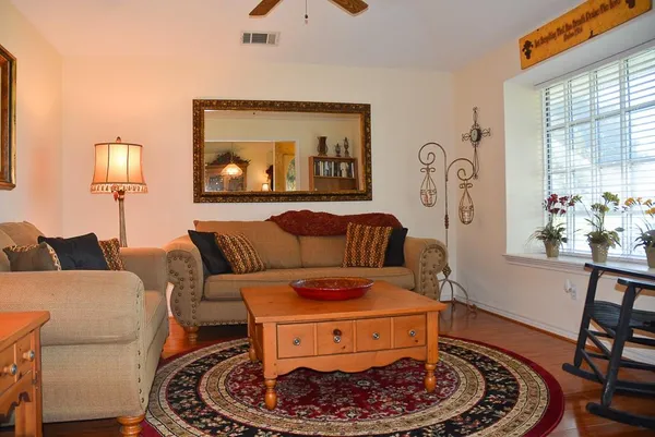 a living room with furniture and a lamp