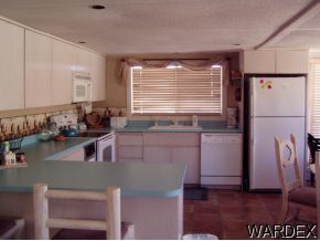 10067 Rio Vista Road Parker, AZ 85344 - Photo 4 of 10 a kitchen with a refrigerator and a sink
