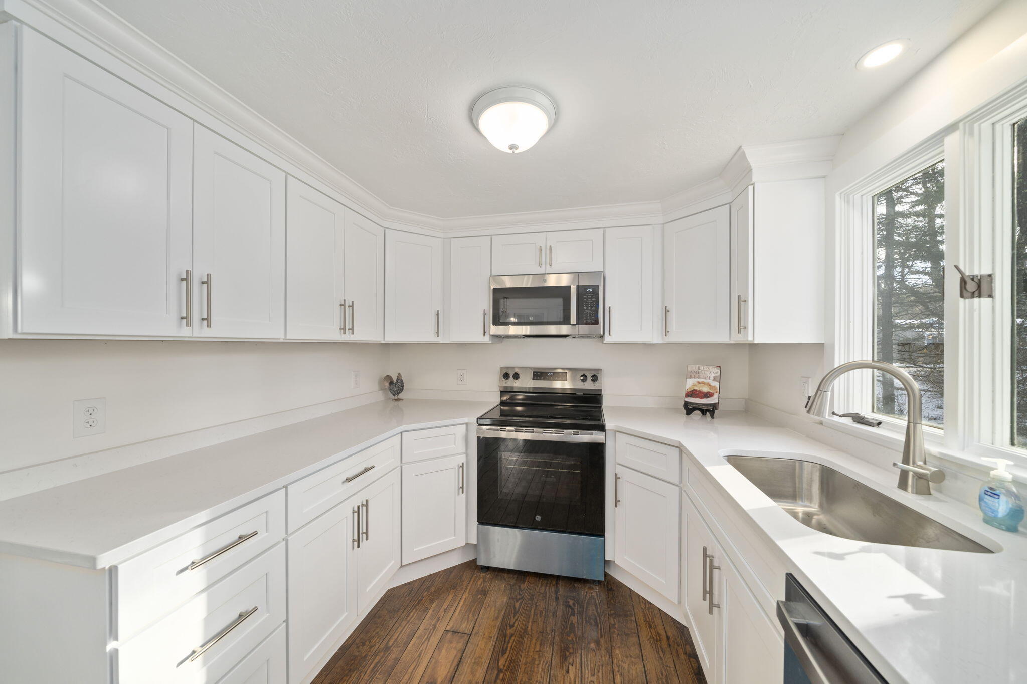10 Sail -A-Way Barnstable, MA 02632 - Photo 5 of 32 a kitchen with white cabinets sink and stainless steel appliances
