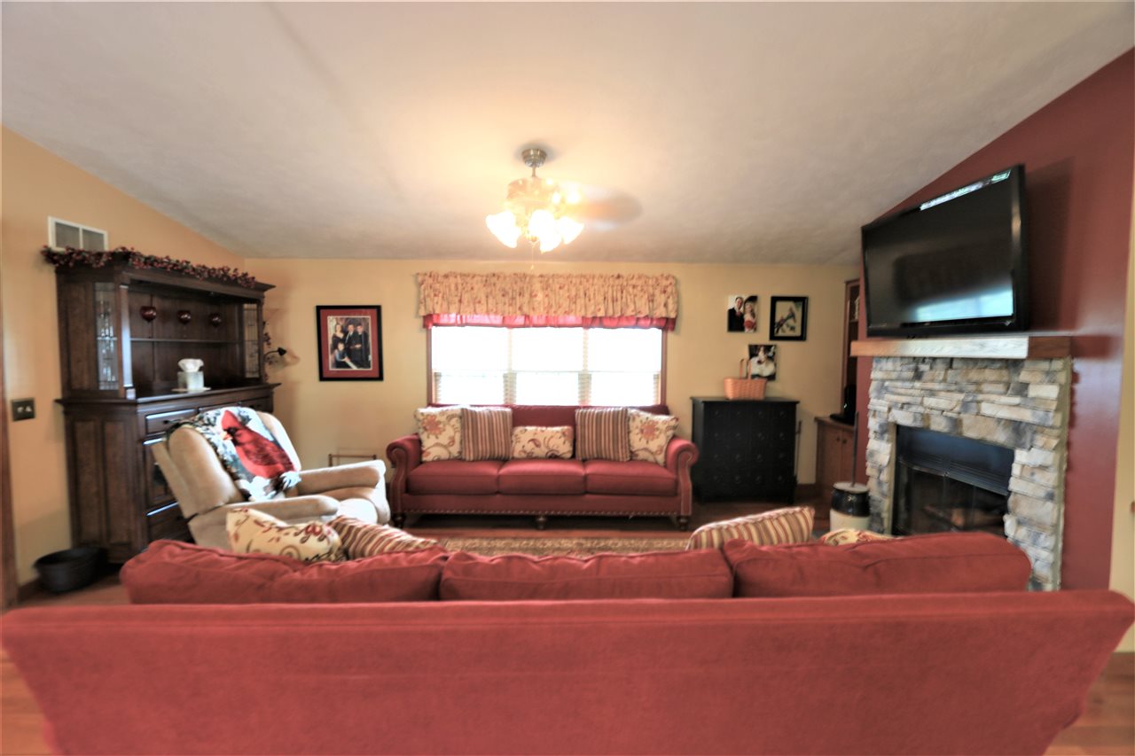 954 Quick's Mill Road Staunton, VA 24401 - Photo 24 of 45 a living room with furniture a fireplace and a flat screen tv