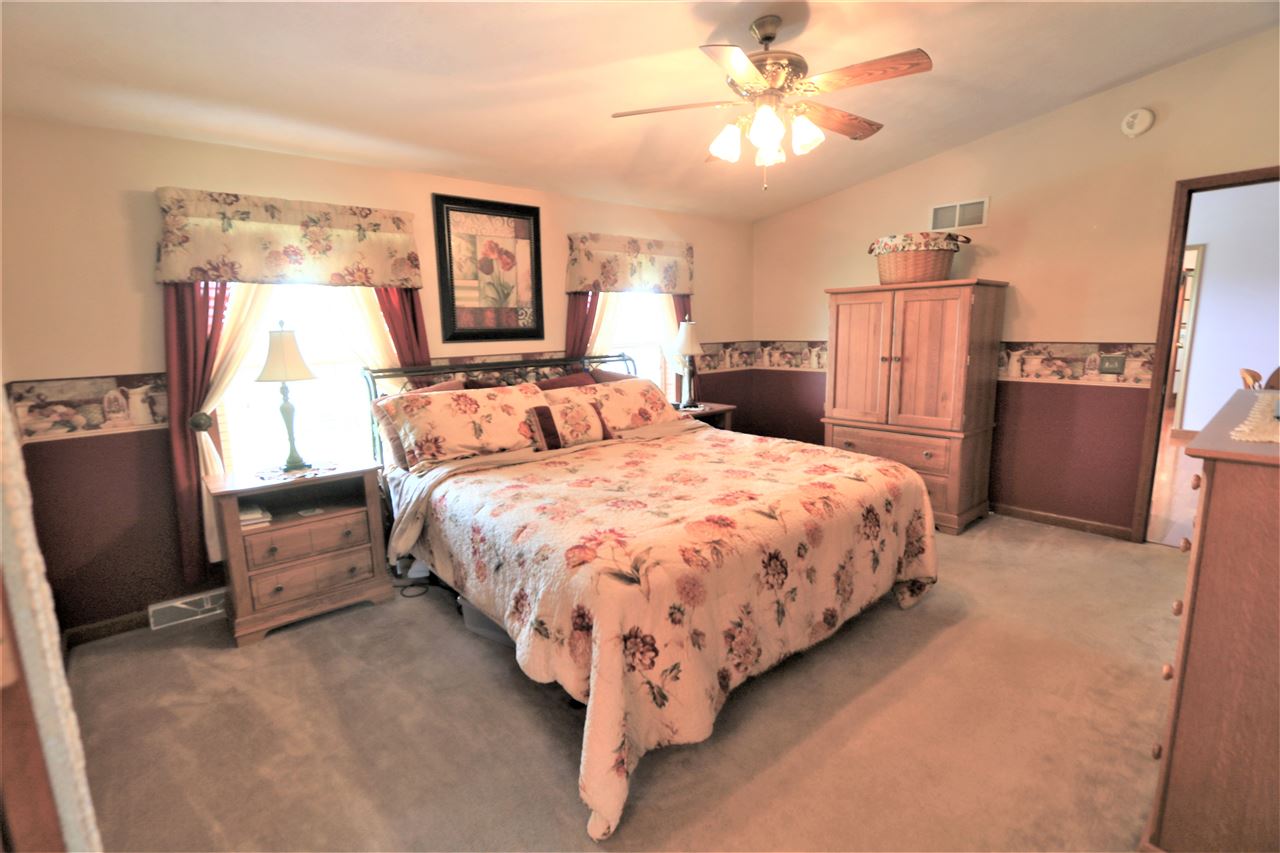 954 Quick's Mill Road Staunton, VA 24401 - Photo 36 of 45 a bed room with a bed and a chandelier