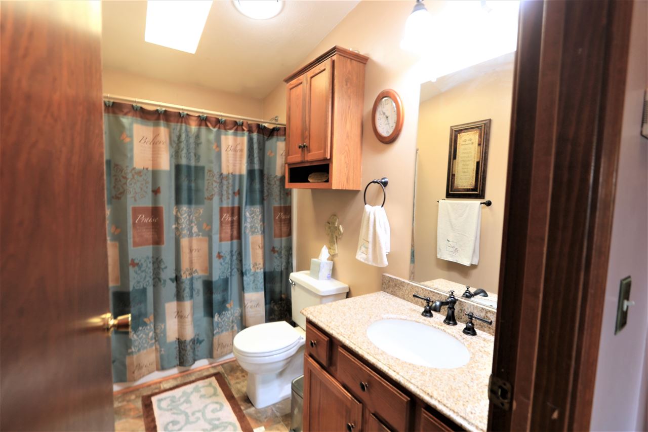 954 Quick's Mill Road Staunton, VA 24401 - Photo 44 of 45 a bathroom with a toilet sink vanity granite and shower