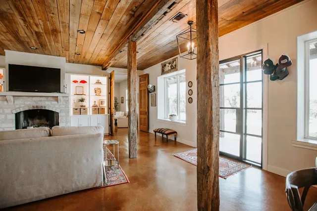 a living room with furniture a flat screen tv and a fireplace