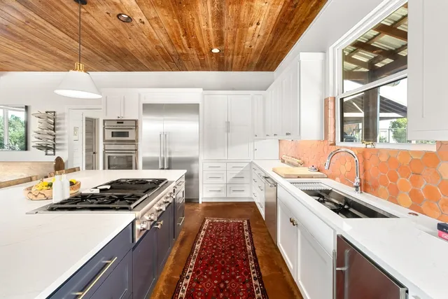 a kitchen with a stove and a refrigerator