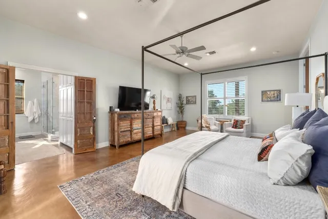a bedroom with a bed window and a television