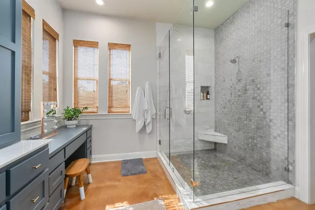 a bathroom with a granite countertop sink a toilet and shower