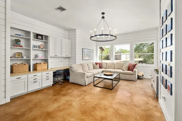 a living room with furniture and a chandelier
