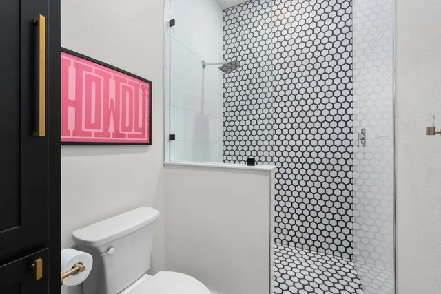 a bathroom with a toilet a sink and a shower