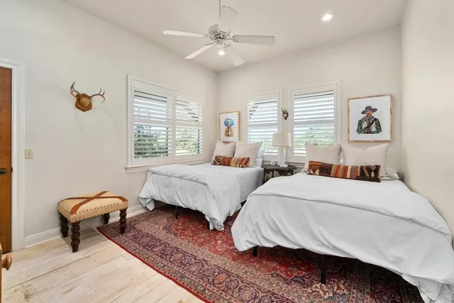 a bedroom with two beds and a window