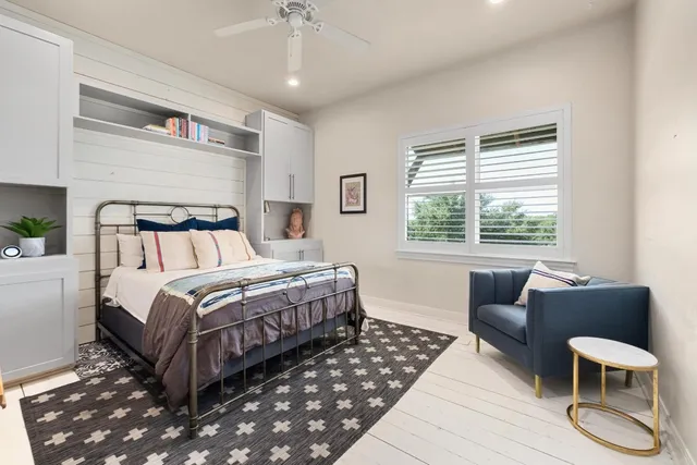 a bedroom with a bed and a large window