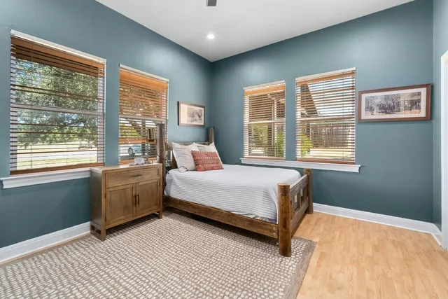 a bedroom with a bed and a large window