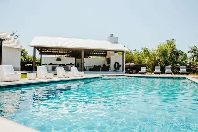 a view of swimming pool with outdoor seating and plants