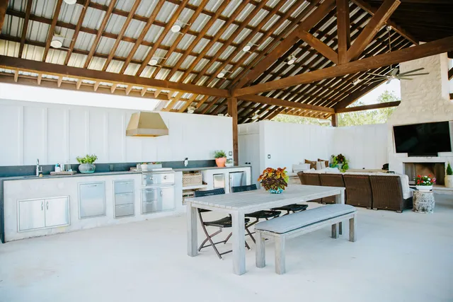 a kitchen with stainless steel appliances kitchen island granite countertop a sink a counter space and windows