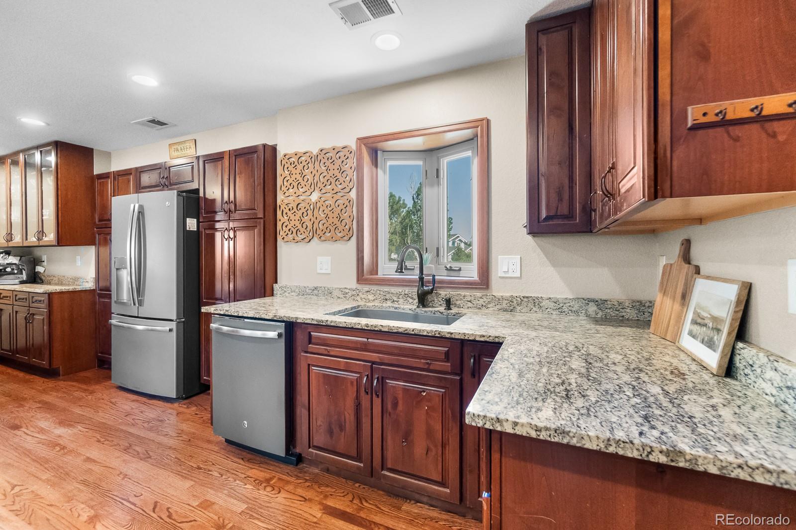 3163 Windstream Lane Elizabeth, CO 80107 - Photo 12 of 48 a kitchen with stainless steel appliances granite countertop a refrigerator and a sink